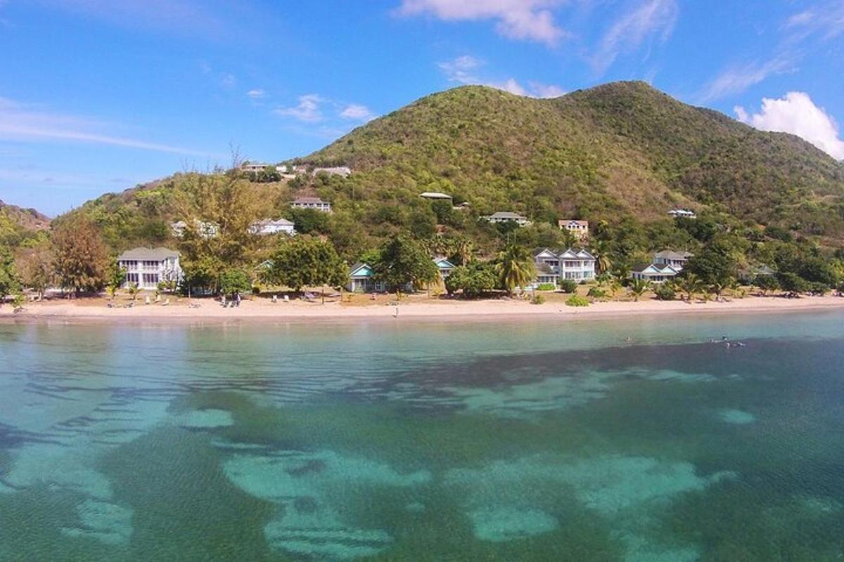 a view of a beach with houses and a mountain