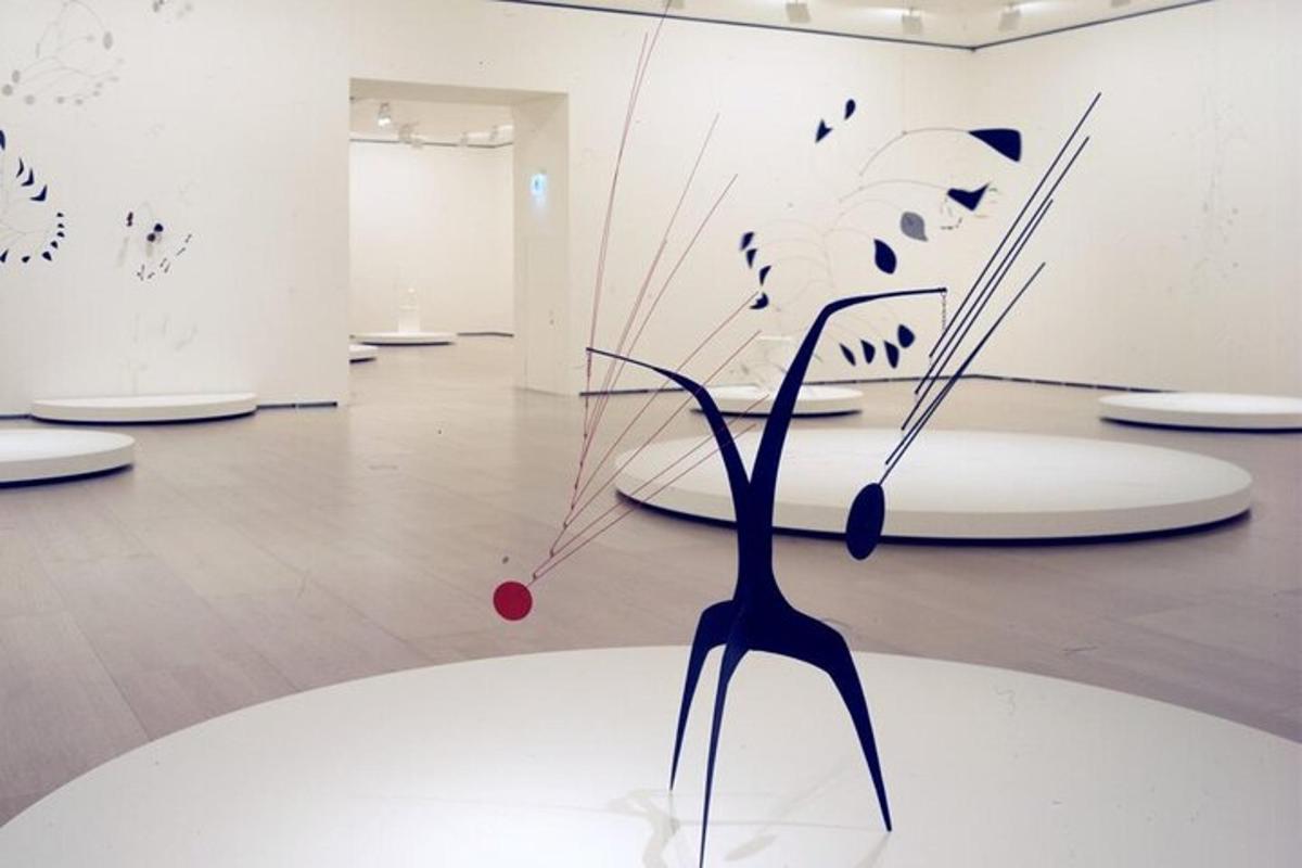 a art exhibit with a glass sculpture on a white plate