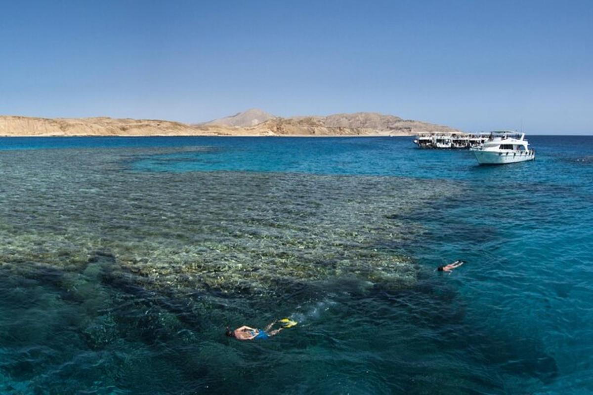 due persone che nuotano nell'oceano con una barca