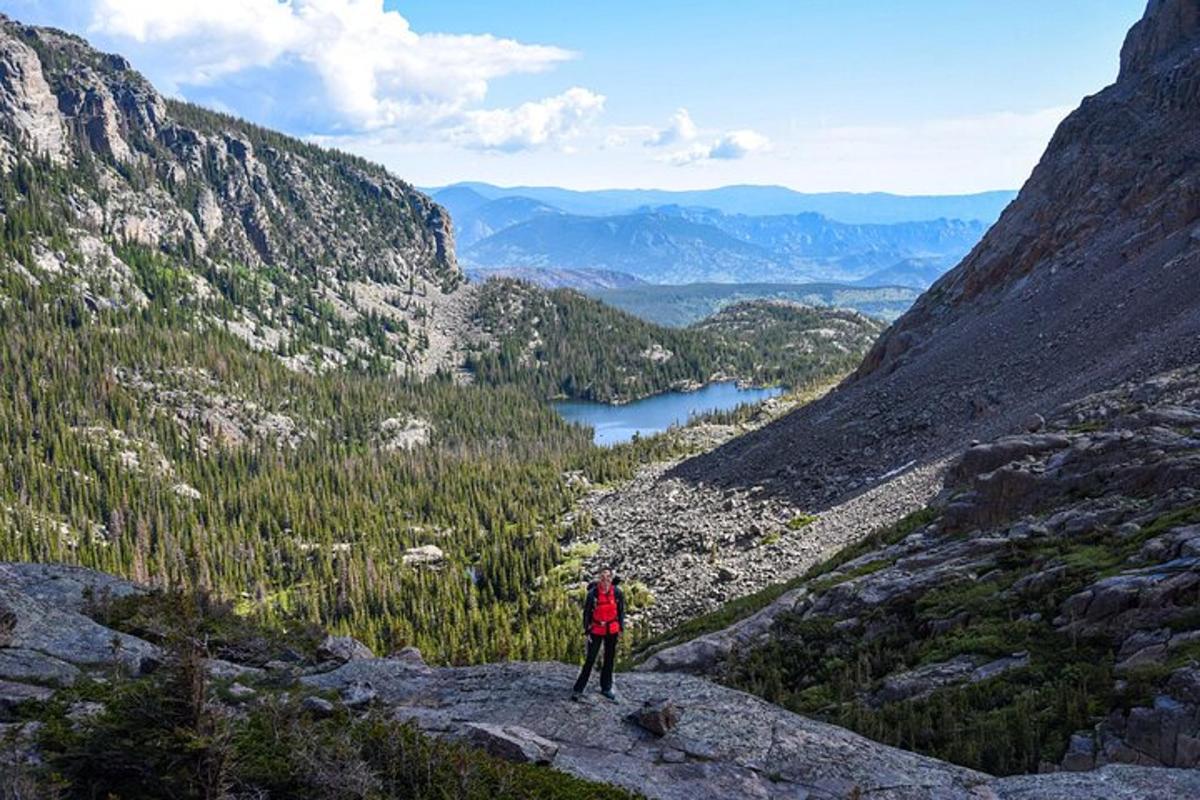 a person standing on top of a mountain overlooking a valley