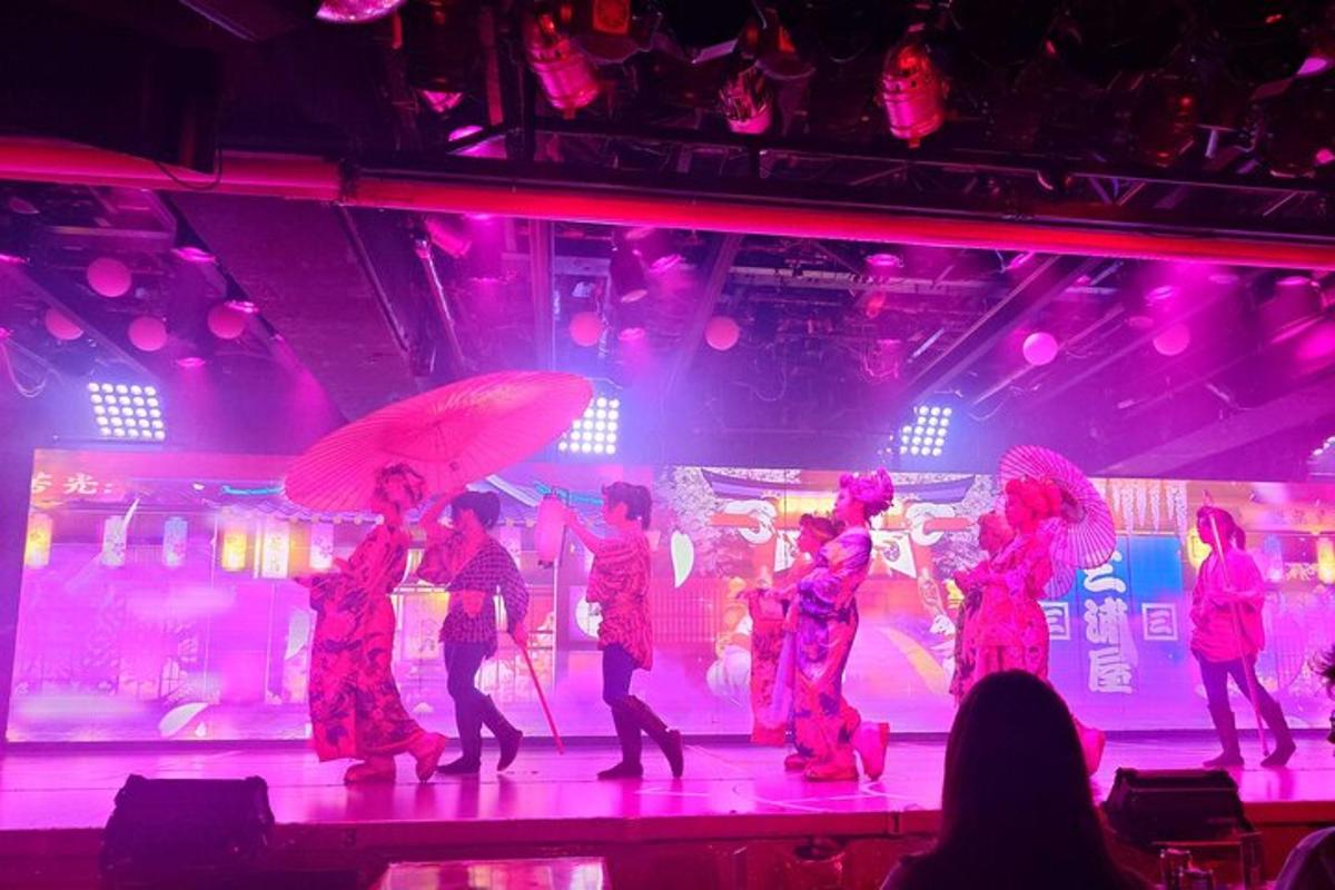 a group of people on a stage holding umbrellas