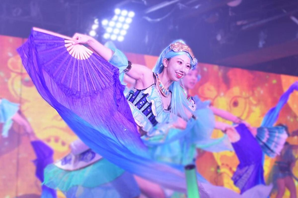 a woman is holding a purple umbrella
