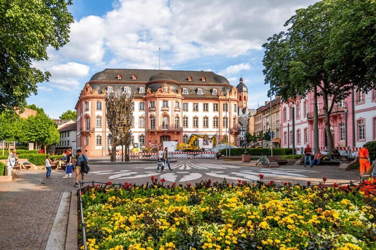 a large building in the middle of a street with flowers
