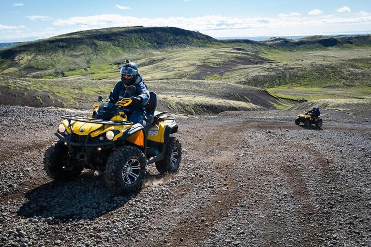 a man riding a four wheeler on a dirt road