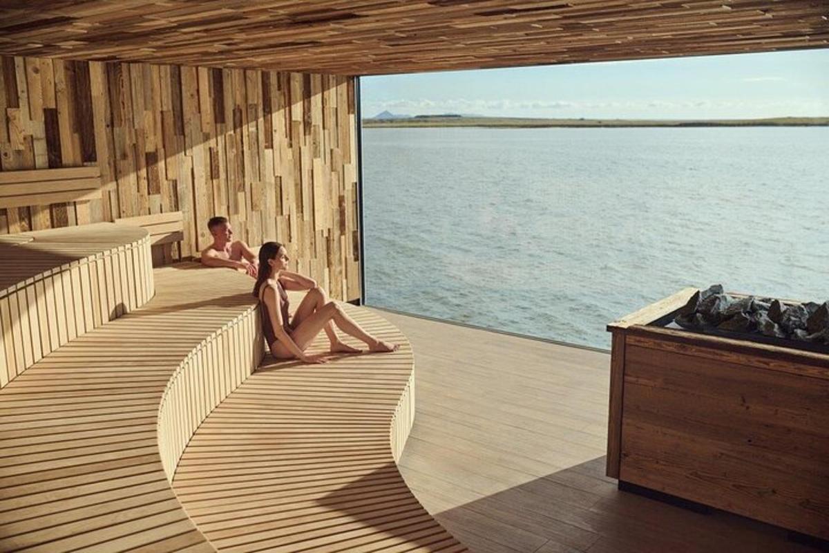 two men sitting on the deck of a boat