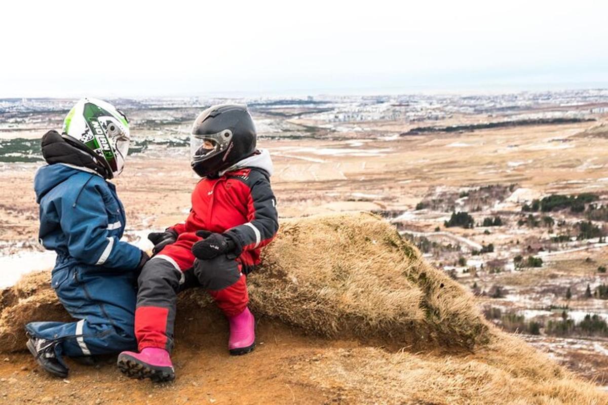 two people sitting on top of a pile of hay