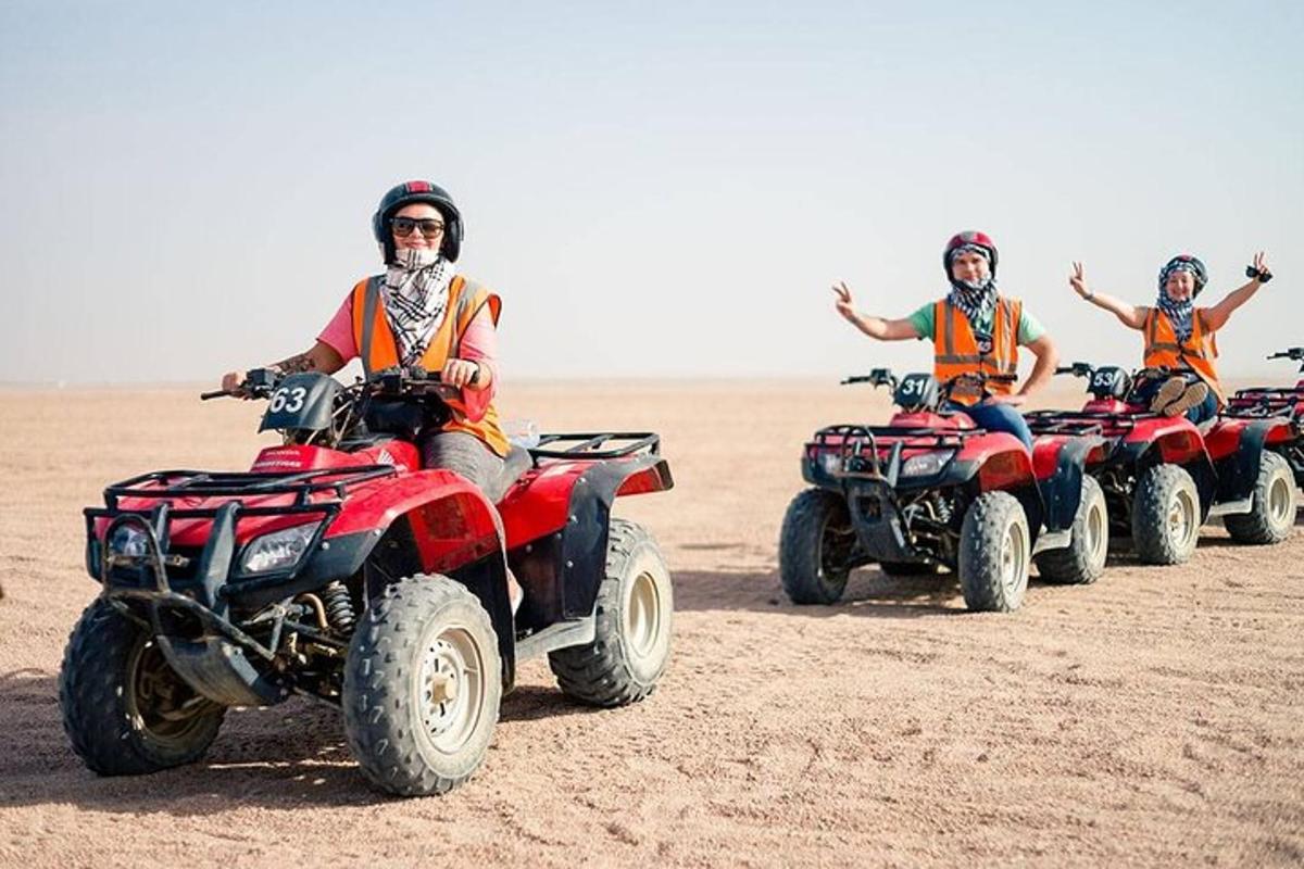 a group of people riding atvs in the desert