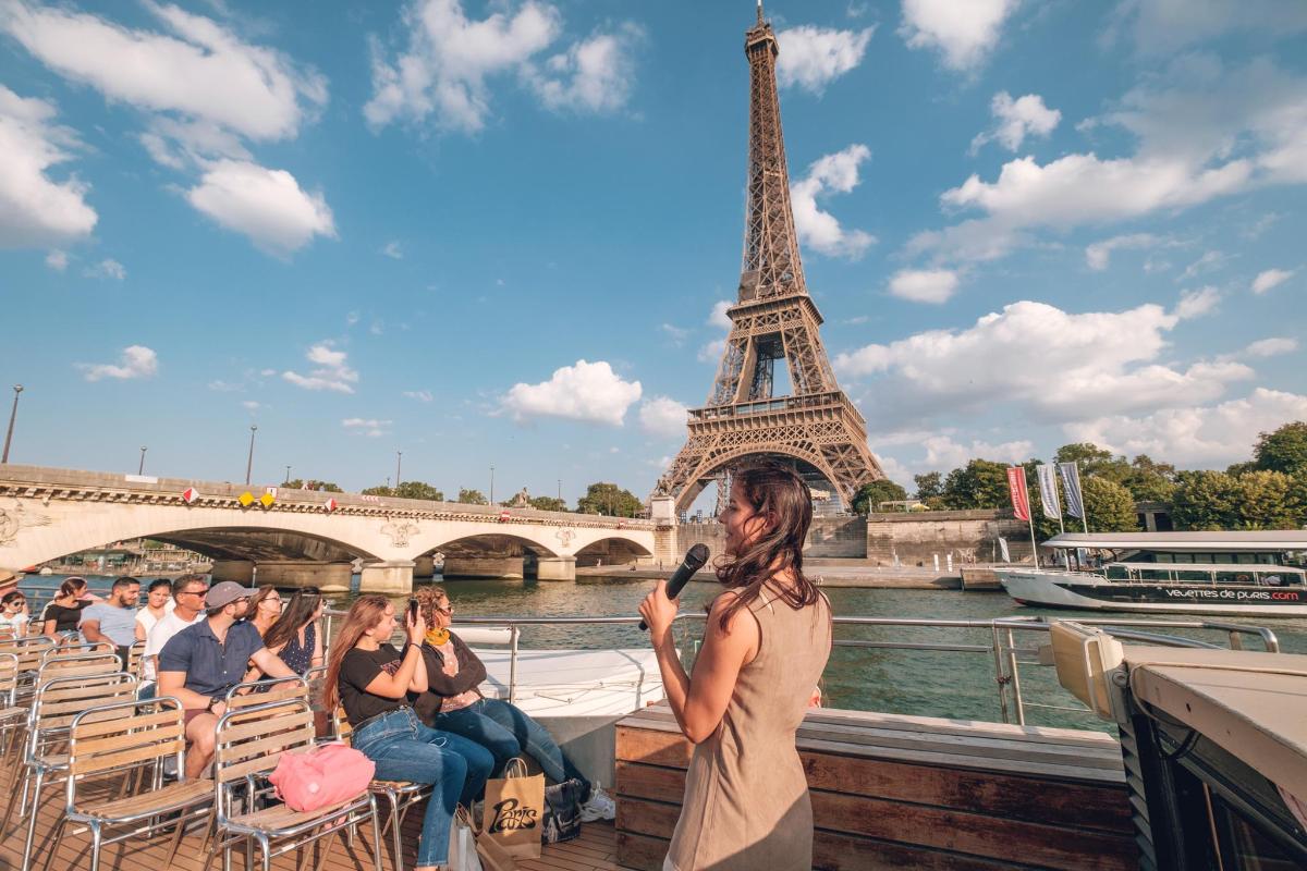a woman on a boat in front of the eiffel tower