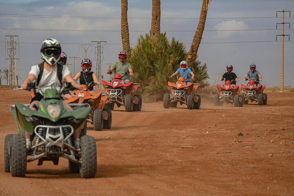 a group of people riding atvs on a dirt road
