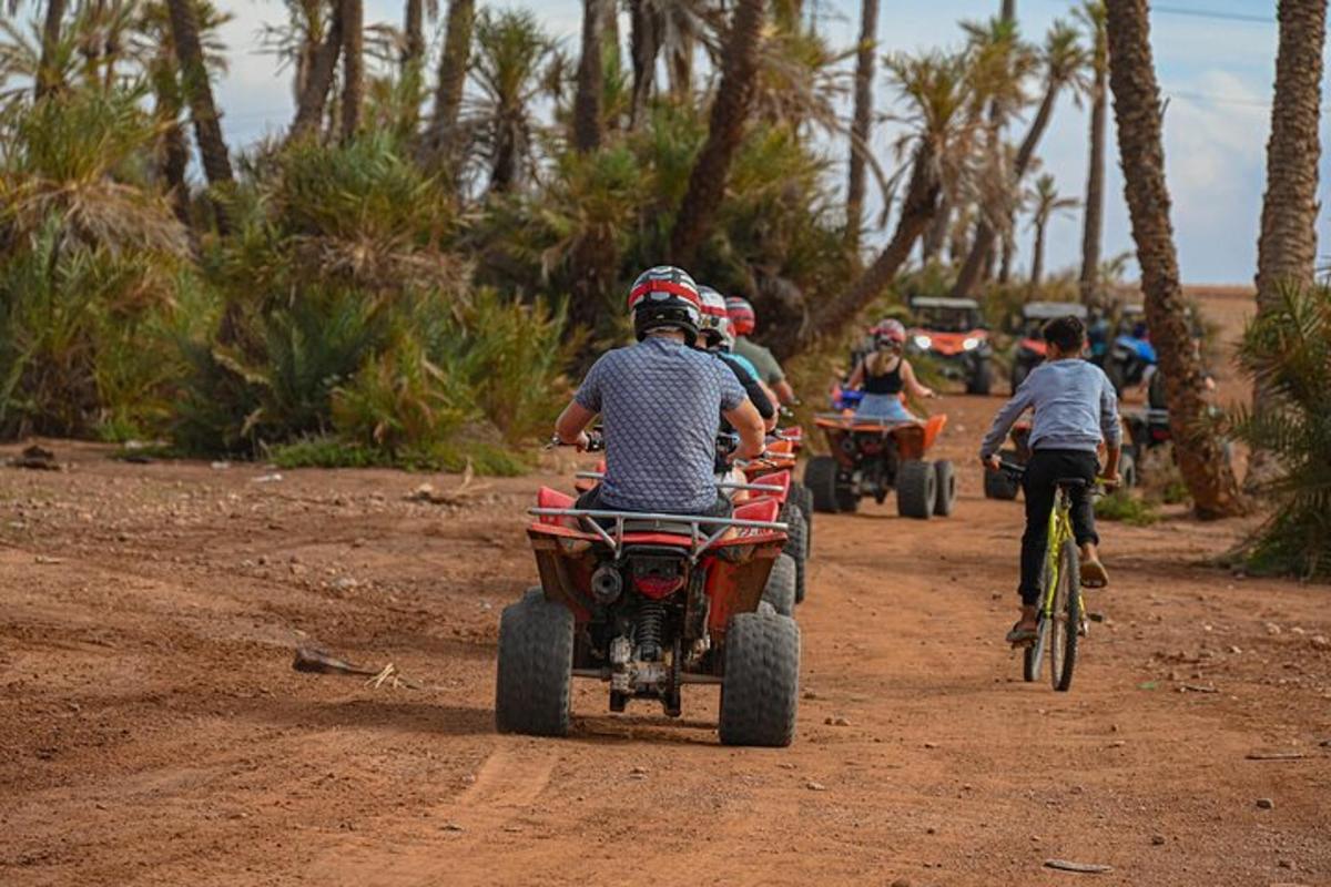 a group of people riding atvs on a dirt road