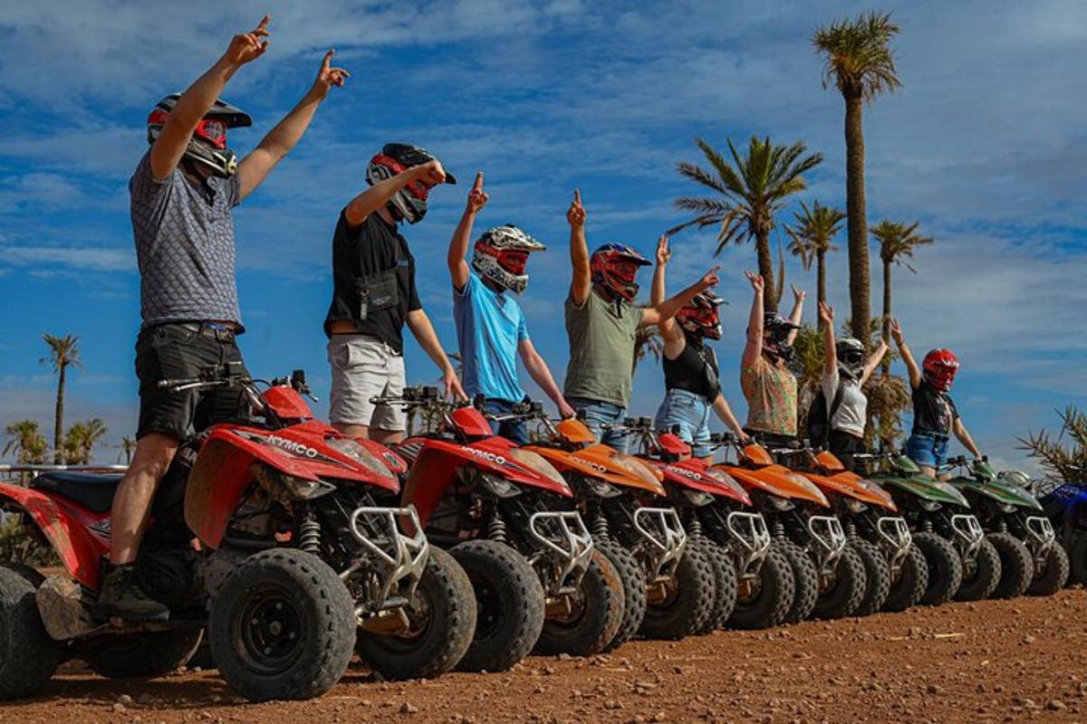 a group of people standing on four wheelers