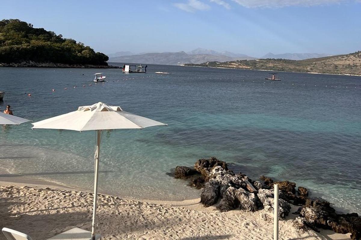 a beach with an umbrella in the water