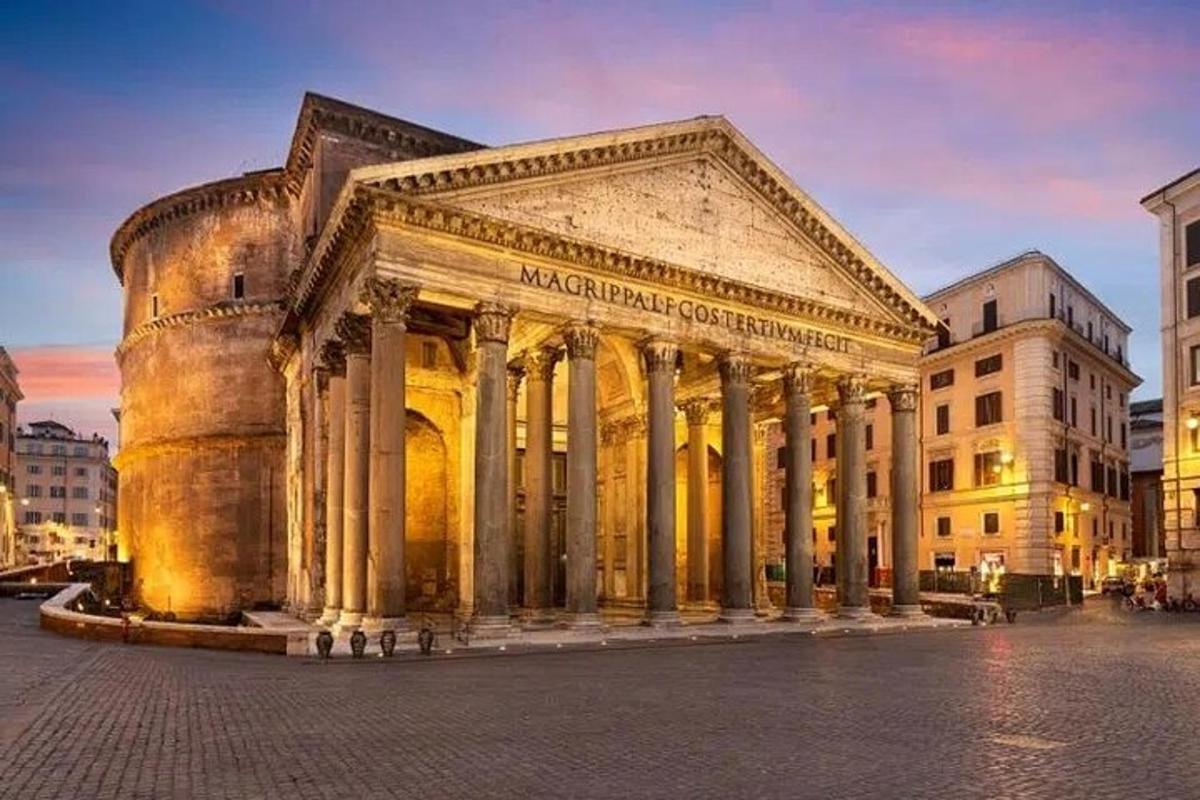 an old building with columns in a city at night