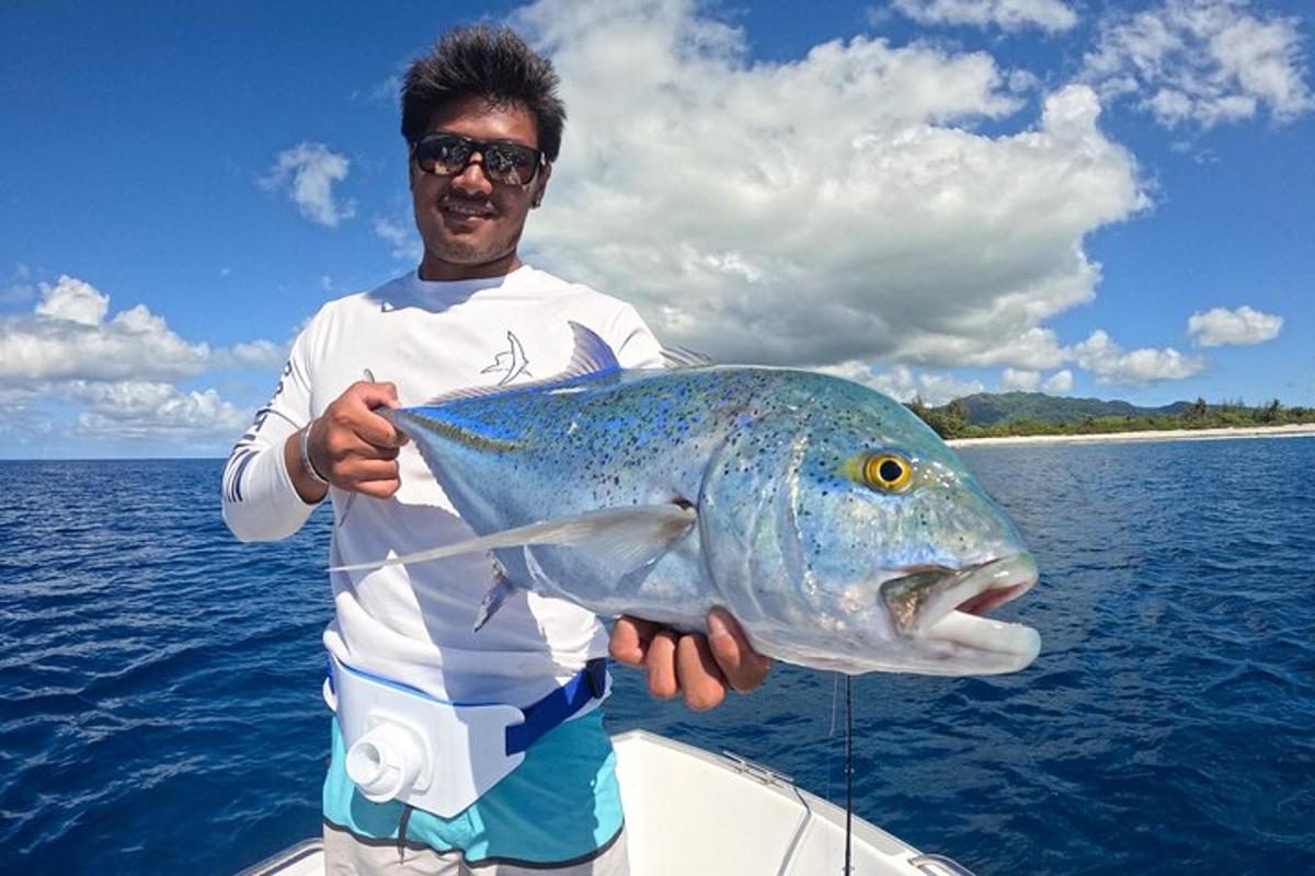 a man holding a large fish in the water