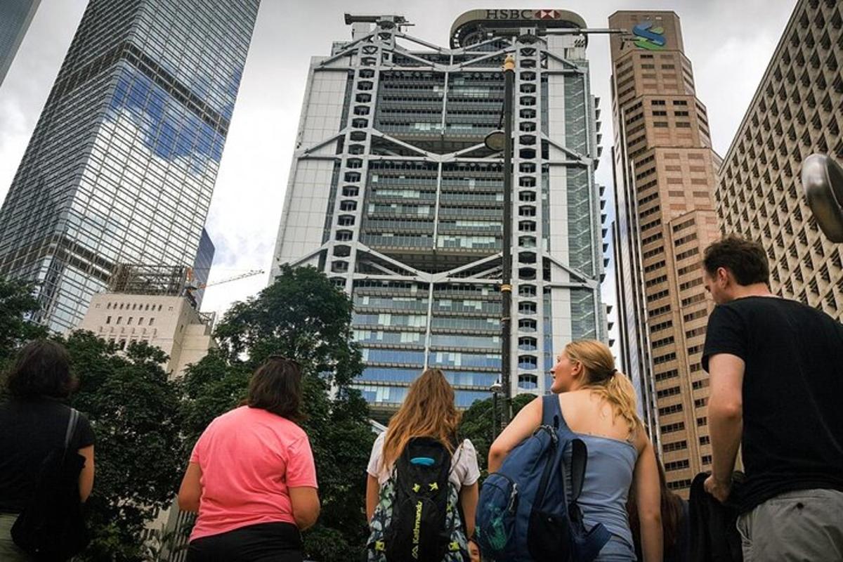 a group of people standing in front of a tall building