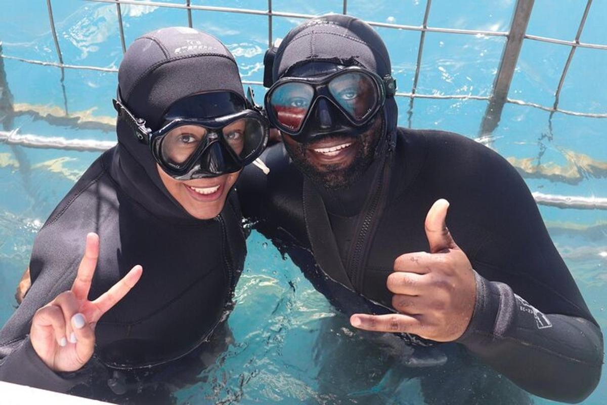 two people in a swimming pool giving the peace signs