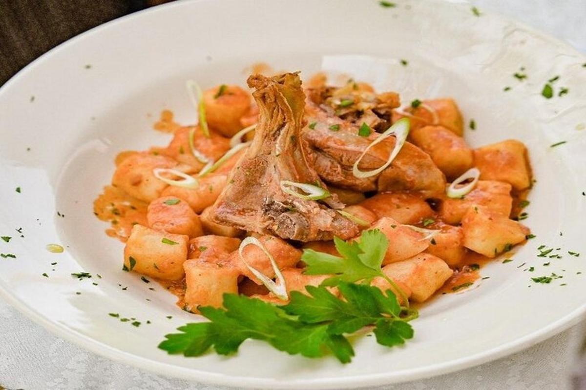 a white plate of food with potatoes and onions