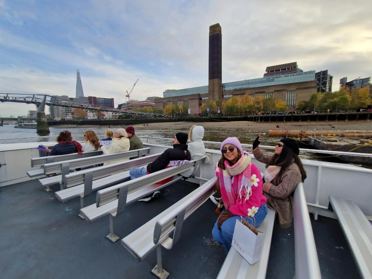 a group of people sitting on benches on a boat