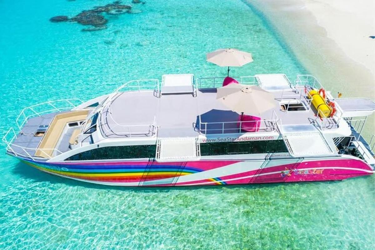 a colorful boat in the water with an umbrella
