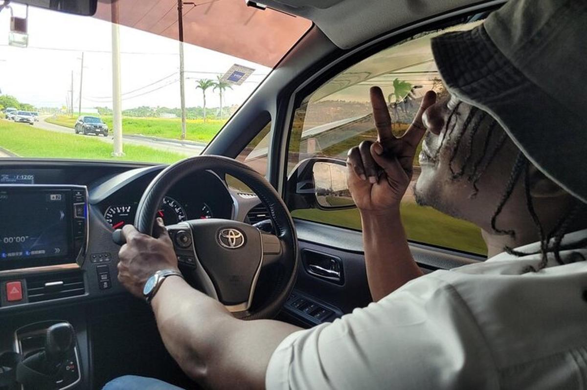 a man driving a car with two donuts on his face