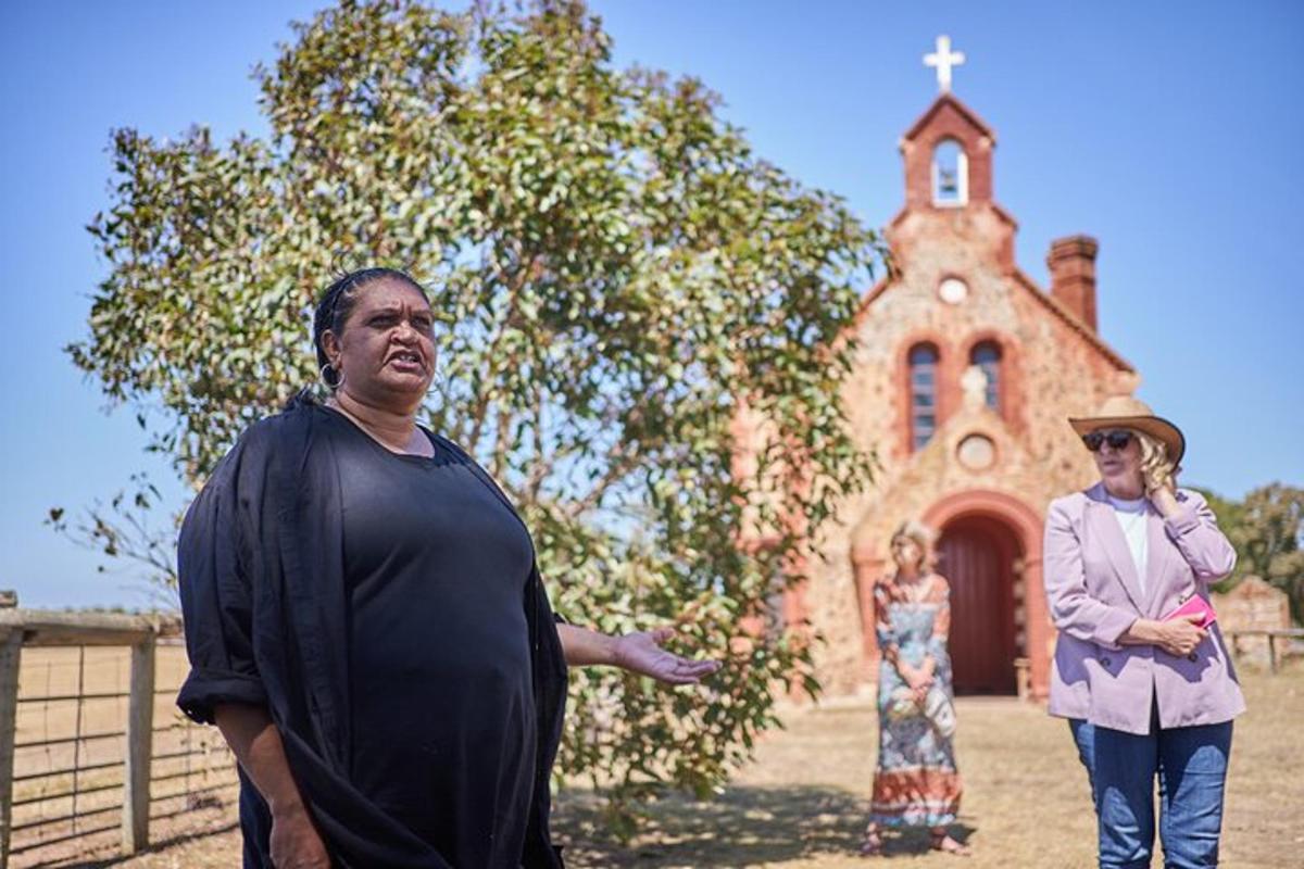 two people standing in front of a church