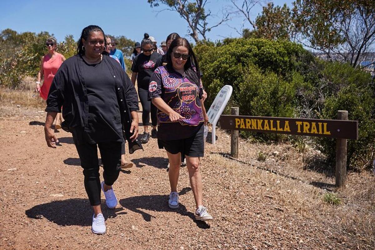 a group of people walking down a trail