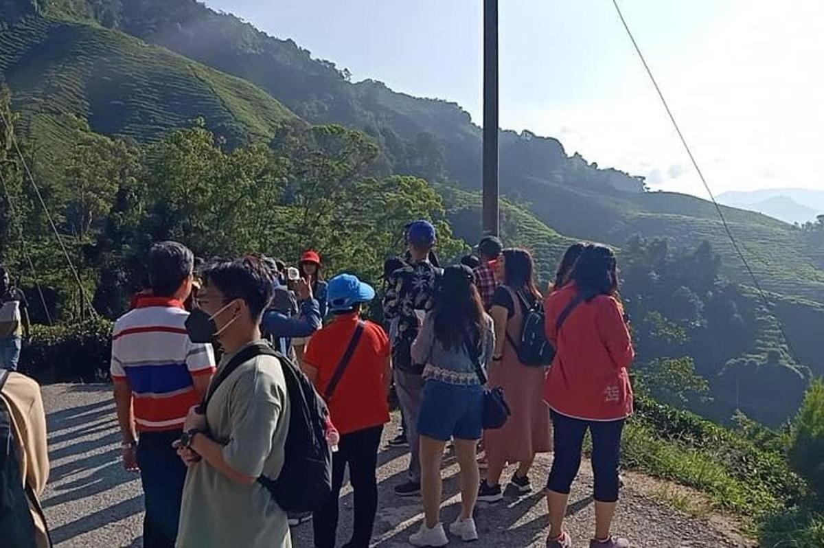 a group of people standing on the side of a mountain