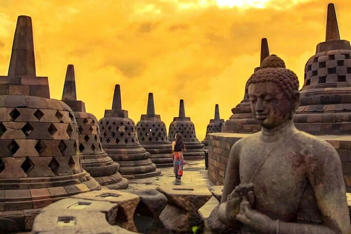 a statue of a man in front of a temple