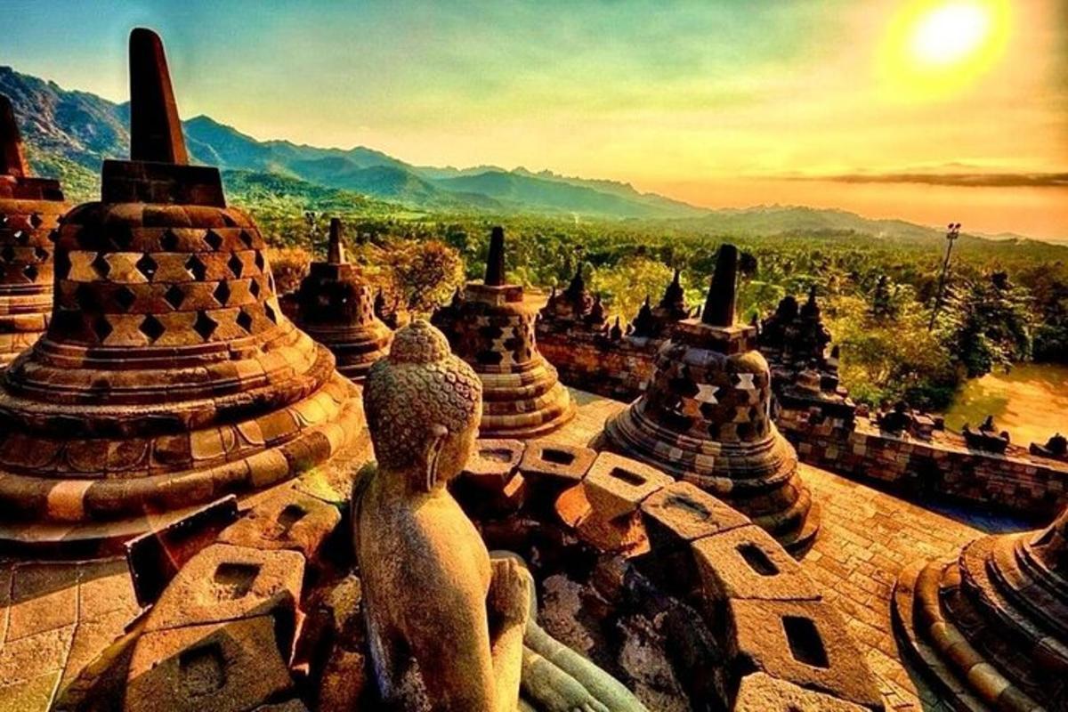 a view of a group of temples with mountains in the background