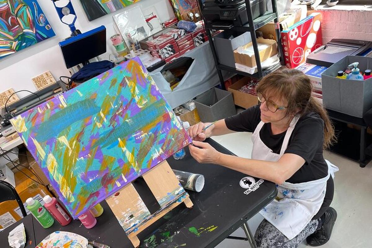 a woman in an office working on a painting