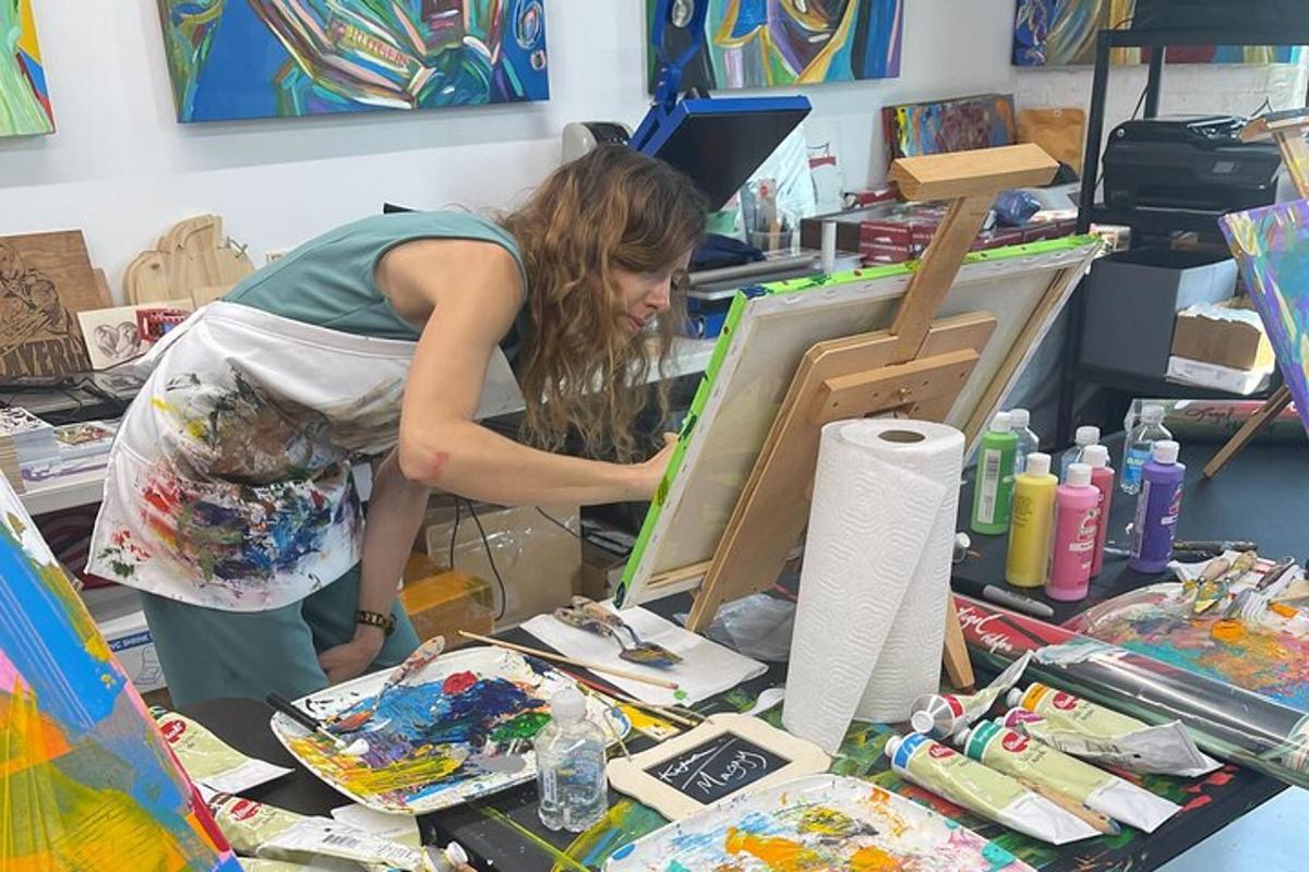 a woman painting a canvas in a art shop