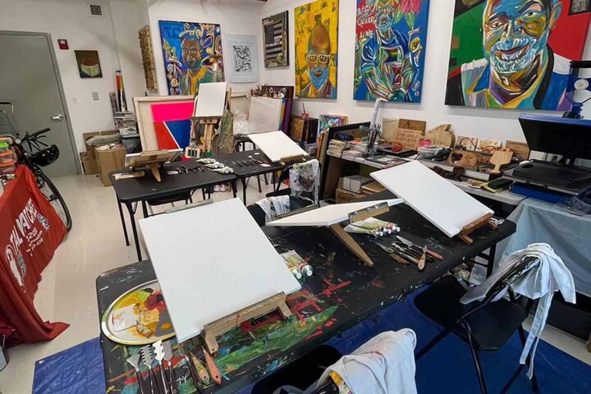 a room with several tables with paintings on the wall