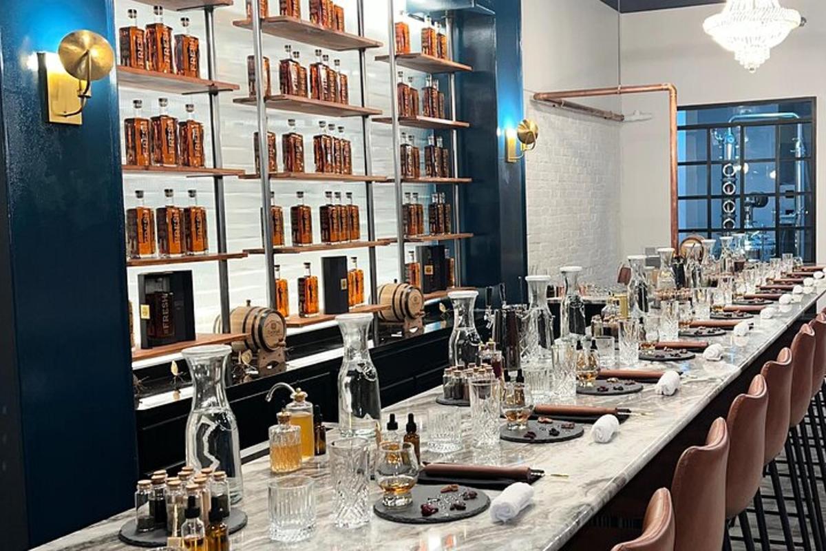 a long table in a room with bottles on the wall