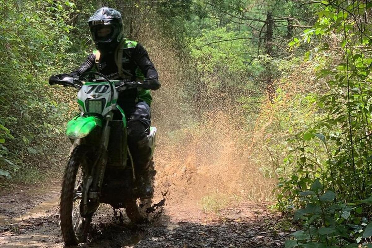 a person riding a dirt bike on a trail