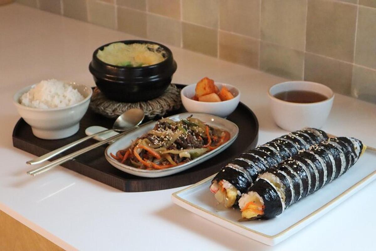 un vassoio di cibo con sushi e riso su un tavolo