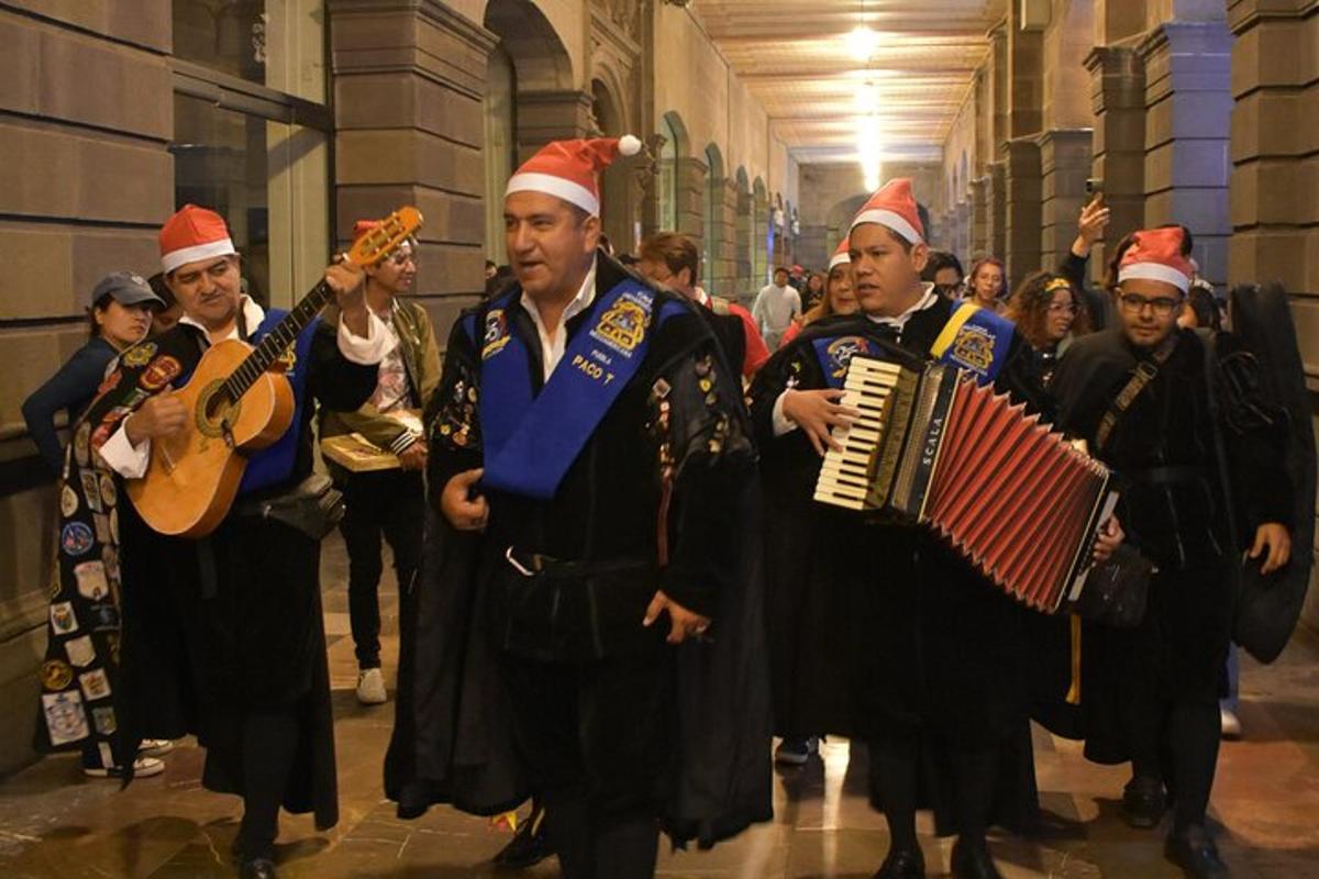 a group of men in santa hats walking down a hallway
