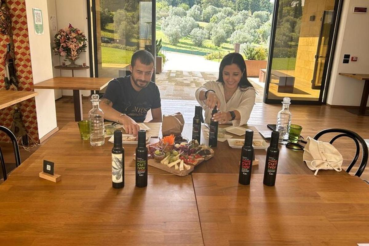 a man and a woman sitting at a table with wine bottles