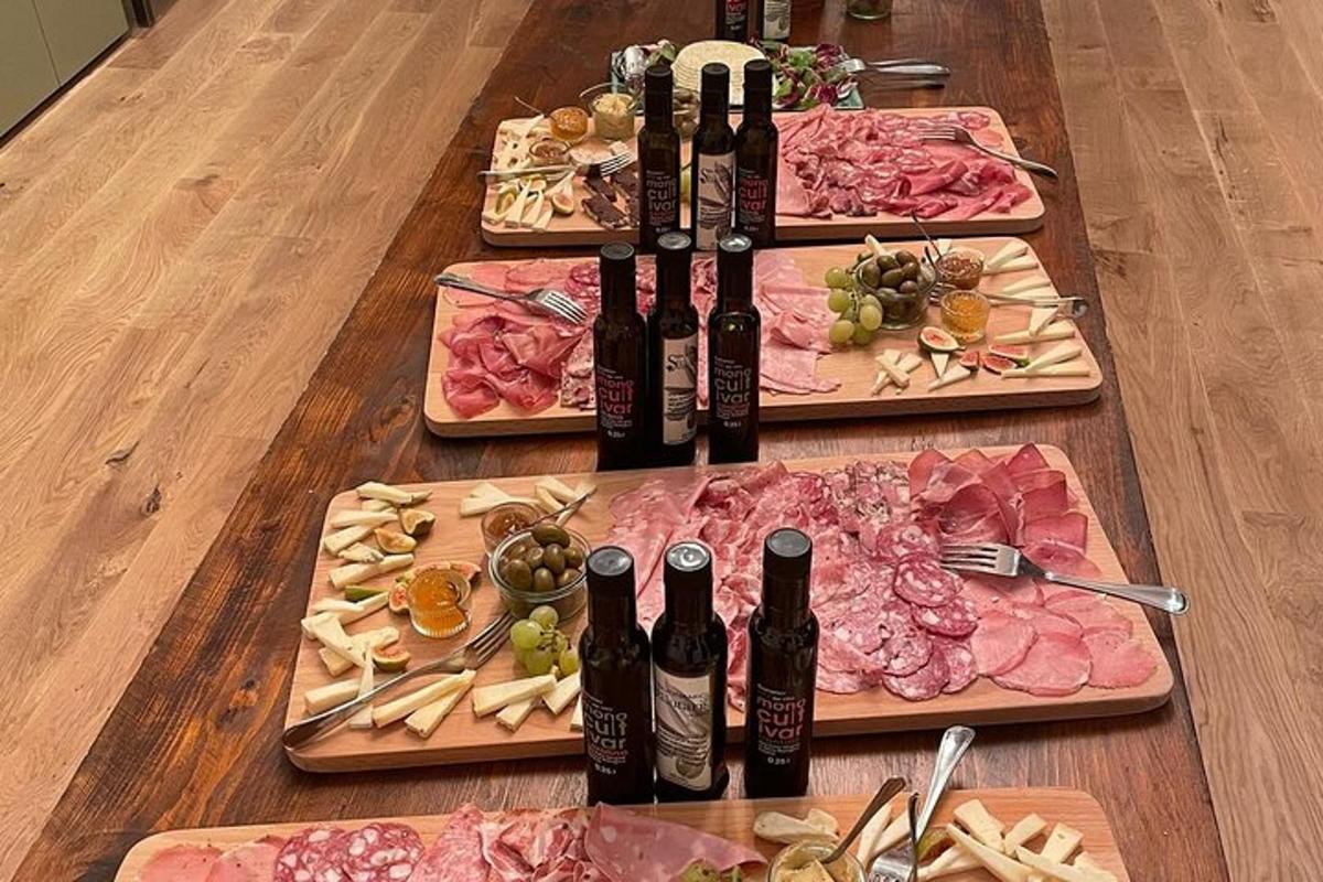 a table topped with plates of food and bottles of wine