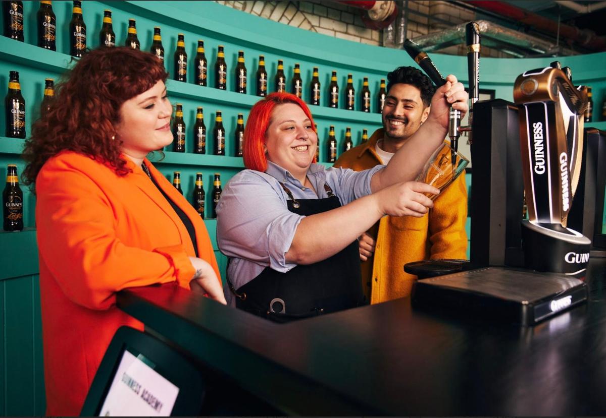 a woman standing at a bar with a bartender