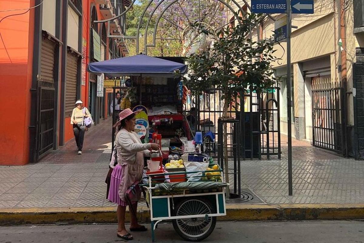 a woman standing next to a food cart on a street