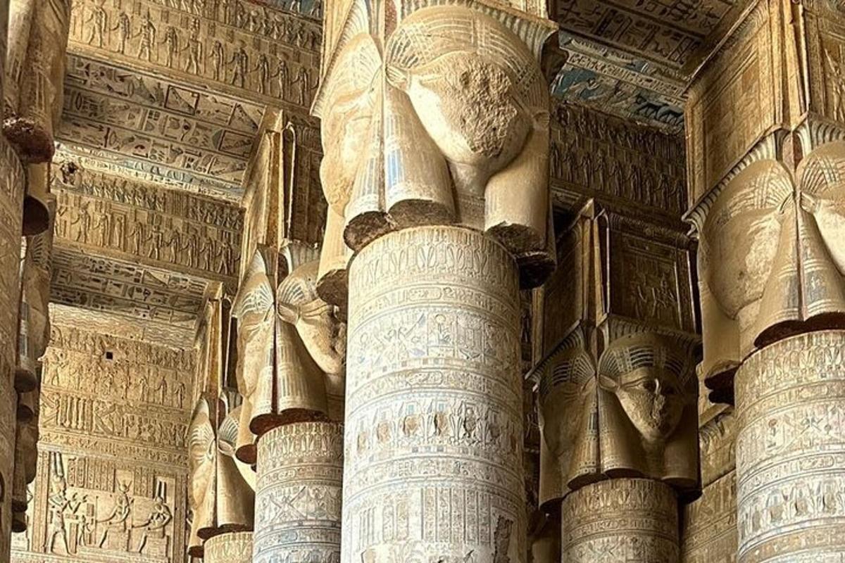 a group of columns in a building with writing on the walls