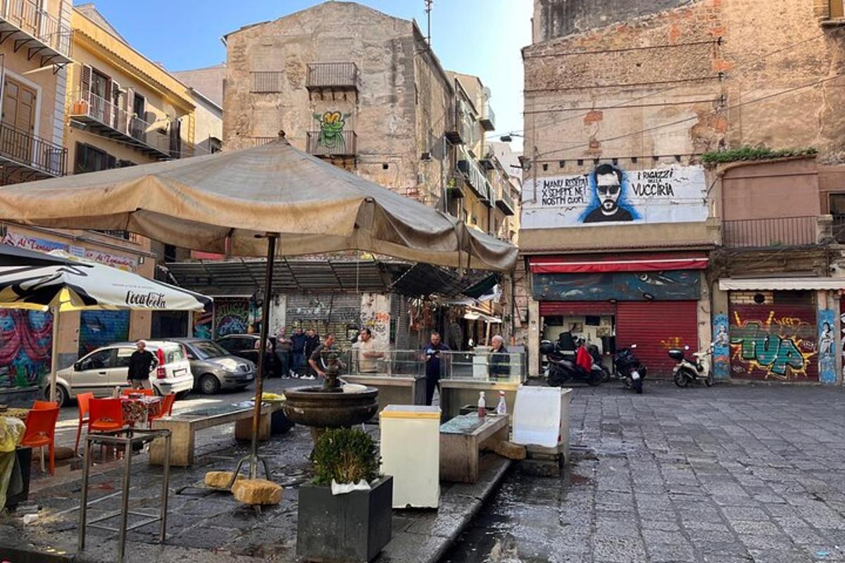 una strada con un ombrellone, tavoli e sedie