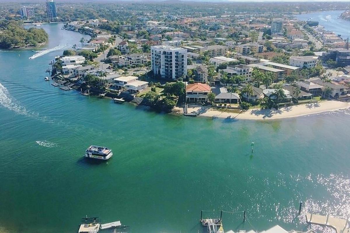 a boat in the water next to a beach