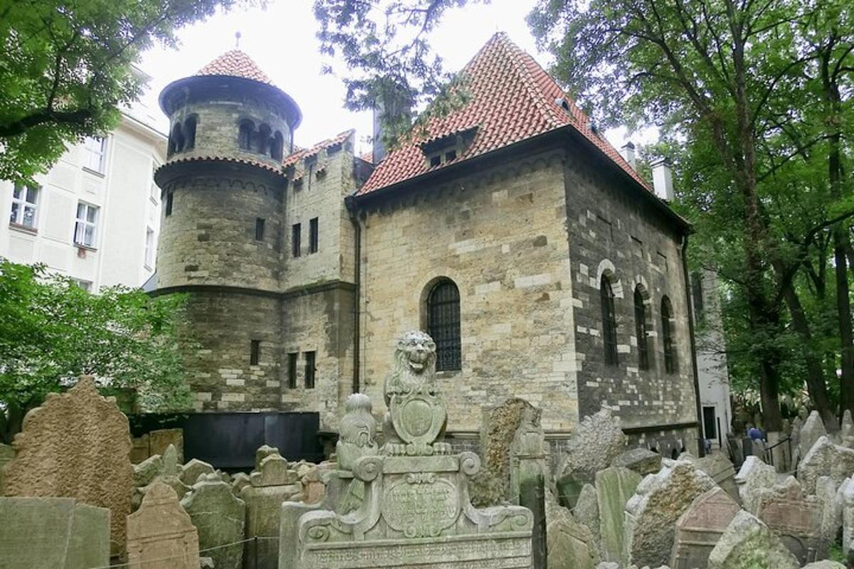 um antigo castelo de pedra com um cemitério na frente