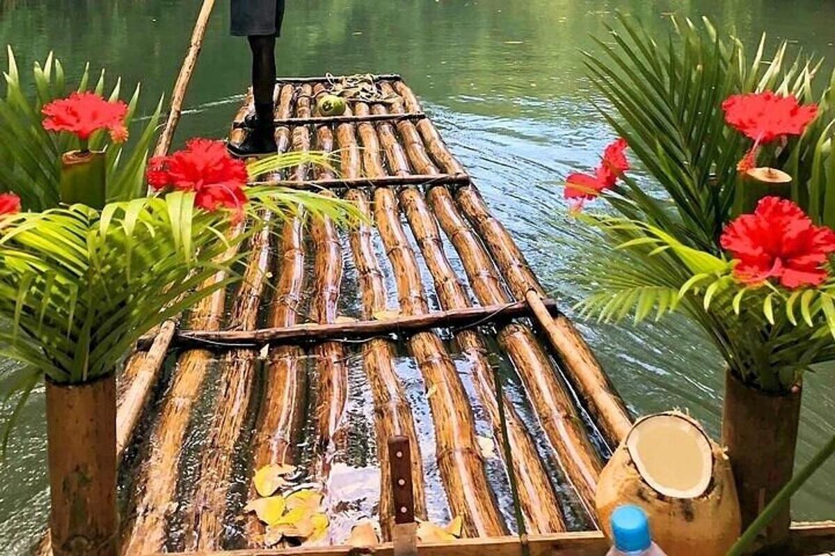 a wooden raft in the water with flowers on it