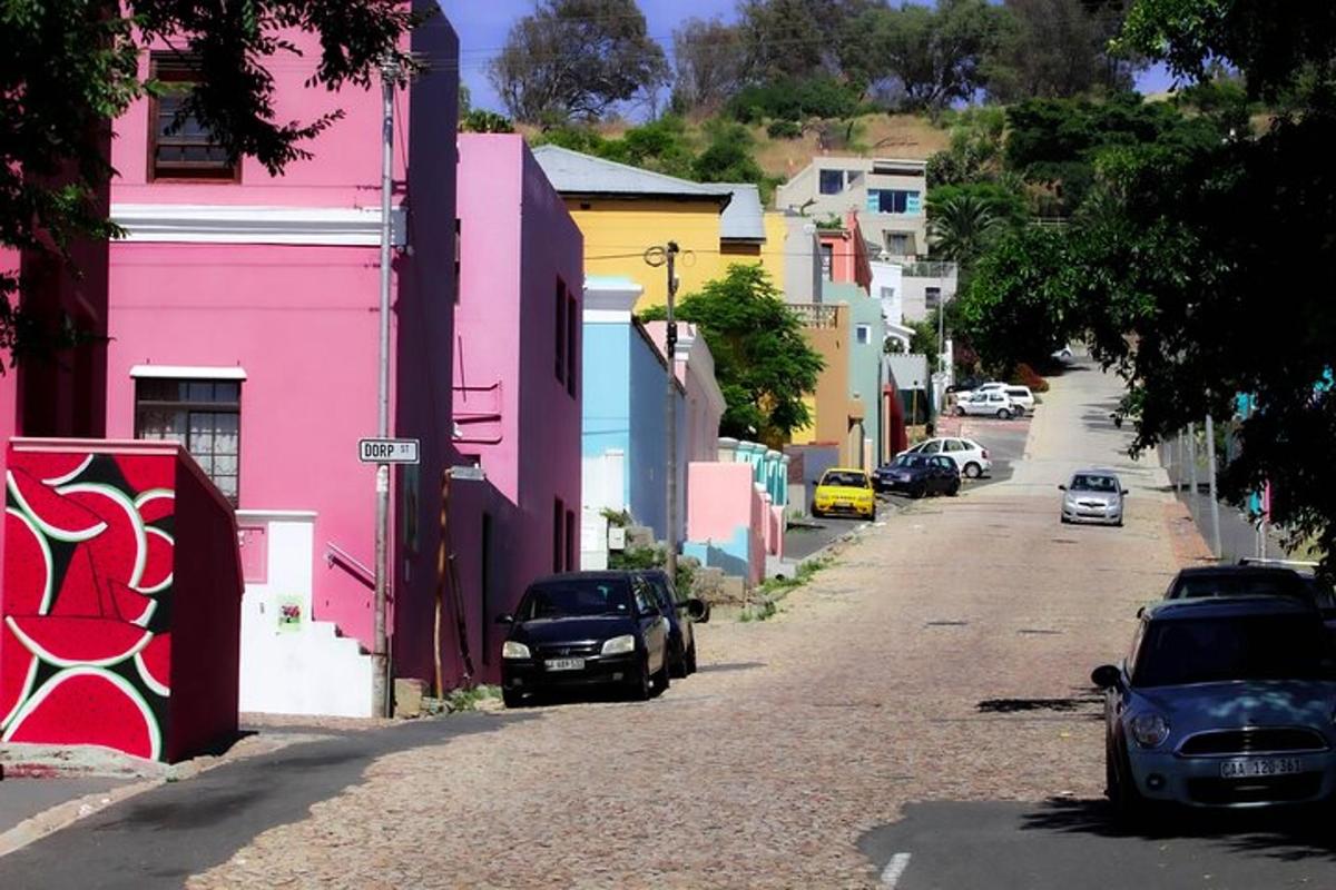 a street with colorful buildings and cars parked on the street