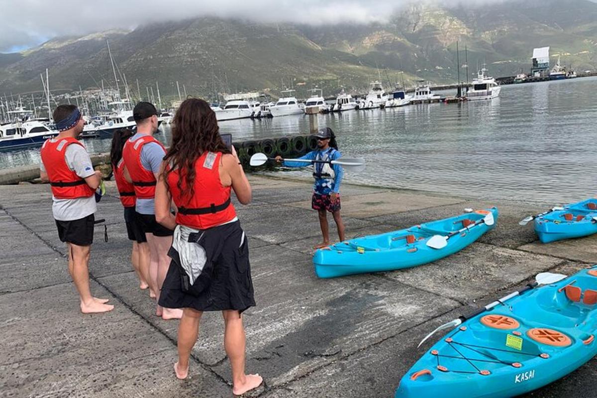 a group of people standing on a dock next to boats