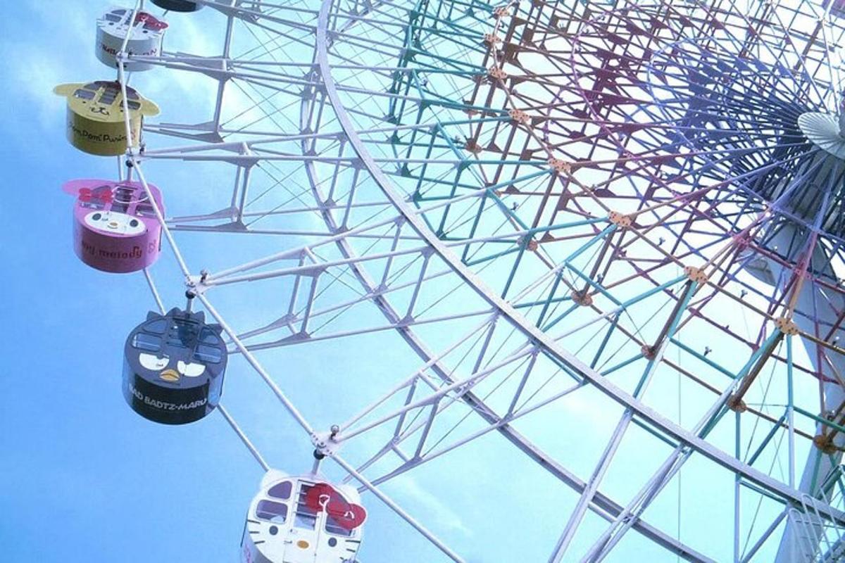 a ferris wheel with two gondolas and a bus