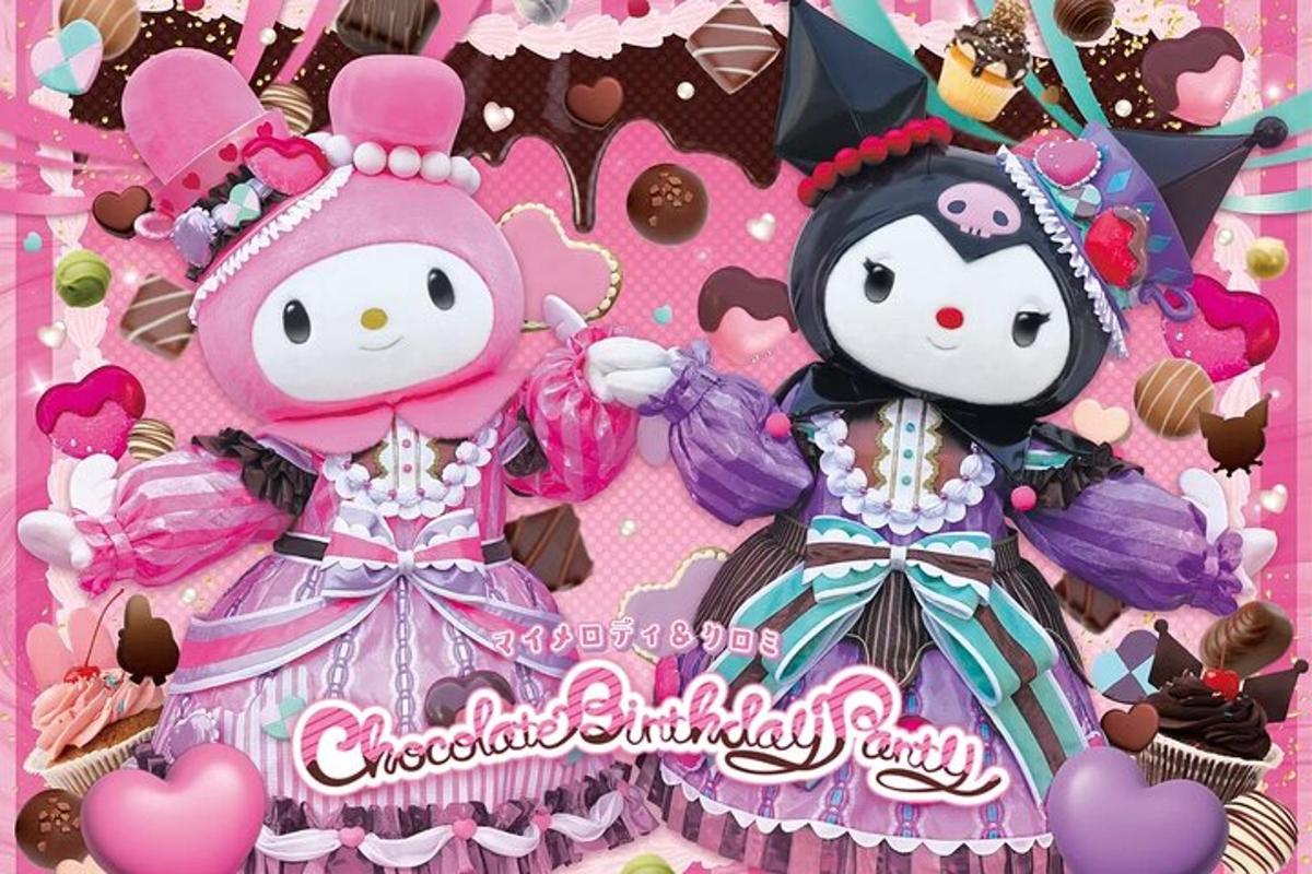 two hello kitty dolls on a pink birthday cake