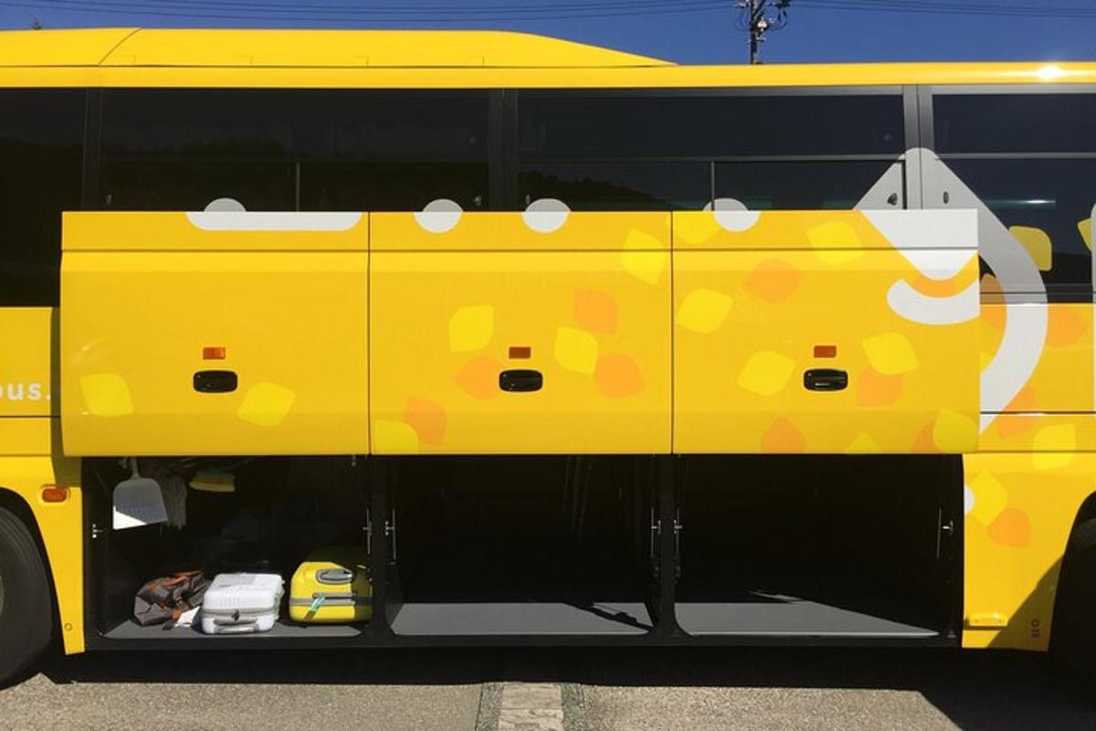 a yellow bus with hello kitty painted on the side